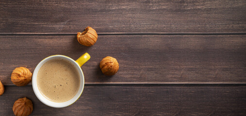 Horizontal banner with coffee with place for text. Aromatic coffee with pastries on a dark wooden background.