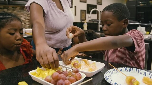 Young Black children, Black girls, Black boy, Black infant baby, Black parents, Black mother, and Black father cooking and eating lunch and dinner at home