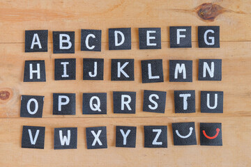 English alphabet letters on wood table.