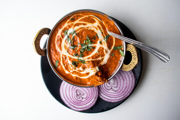 Butter Chicken karahi or chicken makhni with onion and chili served in a dish isolated on grey background top view of bangladesh food - obrazy, fototapety, plakaty