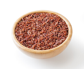 Uncooked red rice in wooden bowl isolated on white background with clipping path