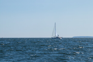 sailboats on the sea with islands in background