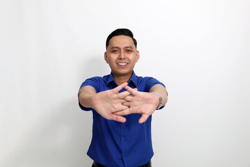 Young asian employee standing while doing stretching his hand. Isolated on white background