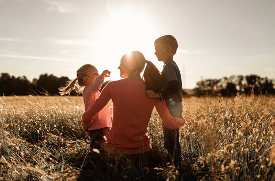 Happy mother's children moment spending time with together outdoors in nature.  Motherhood, and family time concept. 