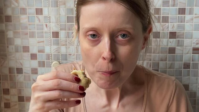 Young woman eating cookies at home interior