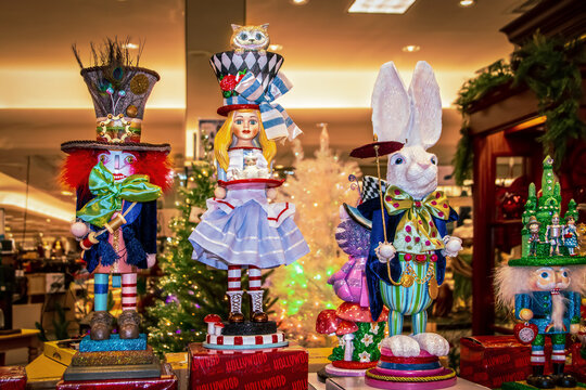 12-17-2021 Tulsa USA Alice in Wonderland Christmas figurines and nutcracker on display in Department store with blurred Christmas trees in background