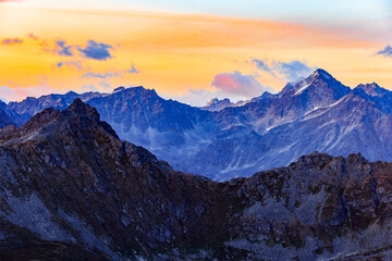 Mountain Range in Hatcher's Pass Alaska with orange sunset and clouds