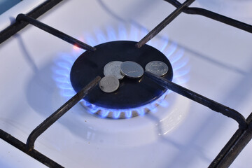 There are metal money on the gas burner.