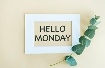 Hello Monday - text on a display lightbox on blue and yellow background.