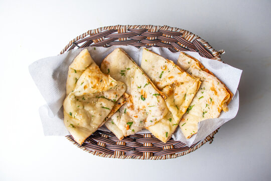 Masala Kulcha Naan served in a basket isolated on grey background top view of bangladesh food