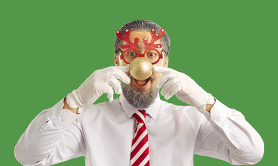 Studio shot of funny man in Christmas costume. Cheerful bearded man in white shirt, striped tie and...