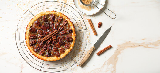 Tasty pecan pie on light background with space for text, top view