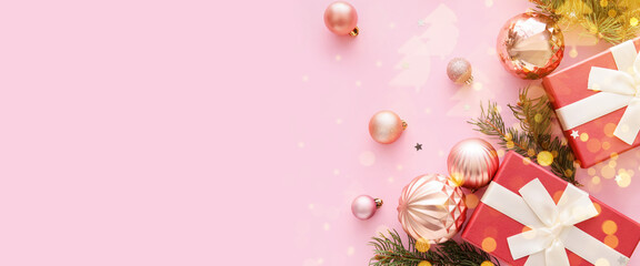 Composition with Christmas gift boxes, balls and fir branches on pink background with space for text