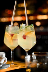 cocktail of raspberry mojito in glasses with straw and ice cubes.