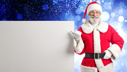 Santa Claus with blank poster on blue background