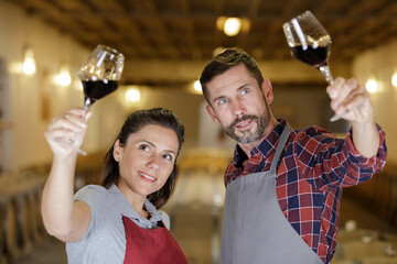 proud couple standing in wine cellar