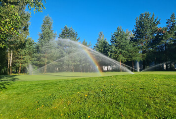 Sprinkler automatic watering for garden lawn and golf courses - obrazy, fototapety, plakaty