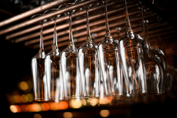 Wine glasses hanging above the bar rack in the restaurant.