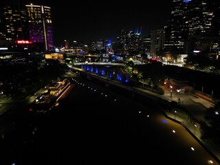 Fototapeta na wymiar aerial view of Melbourne city skyline at night High rise apartments and office space lit up in the dark displaying the City skyline