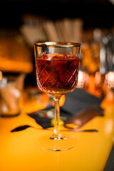 close-up view of beautiful crystal goblet with red alcoholic drink on bar counter