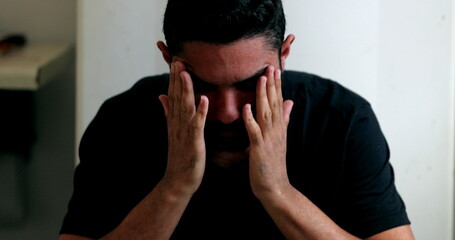 Fototapeta premium Anxious hispanic man feeling worry and PREOCCUPATION