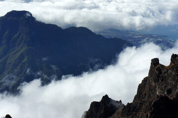 On top of the island of La Palma. The coast of the island is visible between a thick layer of clouds. Canary Islands.