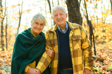 Beautiful Elderly couple embracing in autumn park