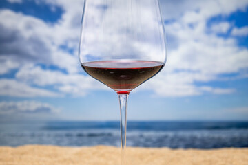 Red wine glass by the sea
