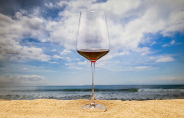 Red wine glass by the sea