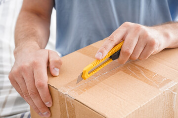 Man opening box with utility box, closeup