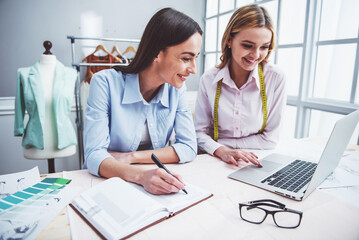 Fototapeta premium Beautiful designers working with gadget