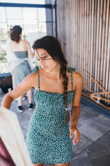 Young woman artist paints with a spatula on the canvas