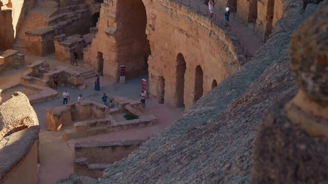 Tourist people visiting antique amphitheatre while excursion. Architecture of old amphitheater Gordian inside.