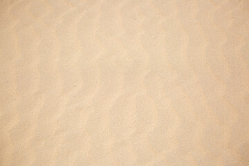 Sandy beach for background. The texture of the sand. Top view of dunes in the desert.