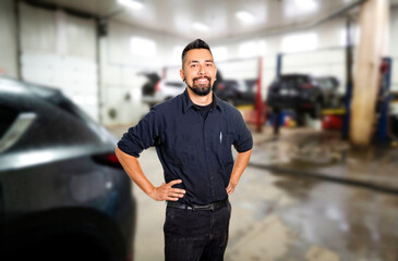 Handsome mechanic job in uniform working on car