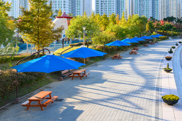 Fototapeta na wymiar Park benches and awnings. Park shade umbrella.