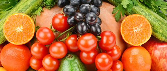 bright background of various vegetables and fruits. Wide photo.