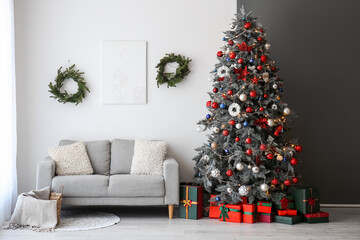 Interior of living room with Christmas tree, presents and sofa