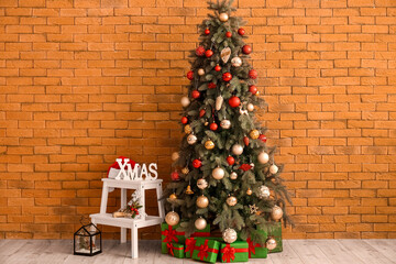 Christmas tree with presents and stepladder near brick wall