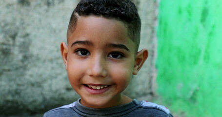 Brazilian child smiling portrait. Close-up hispanic boy face