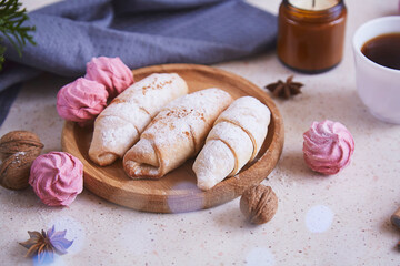 Aesthetic handmade Christmas crescent bagels and marshmallow,star anise, candle and coffee. Cozy home