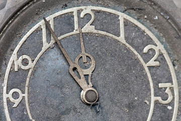 The dial of an old clock. Five minutes to midnight.