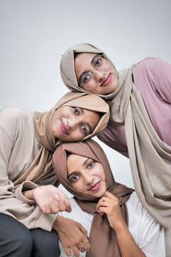 Group Of Young Muslim Women Wearing Hijab at Home