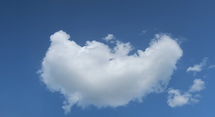 Heart shaped cloud in blue sky background