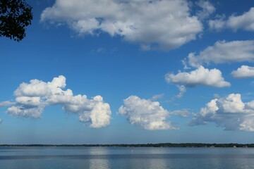 Naklejka na ściany i meble Beautiful clouds in blue sky over the river in Florida nature