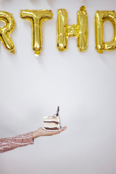 Hand holding a Piece of Cake