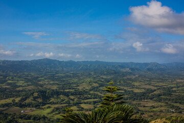 Fototapeta na wymiar Green mountains and valleys of the island of Haiti. Blue mountai