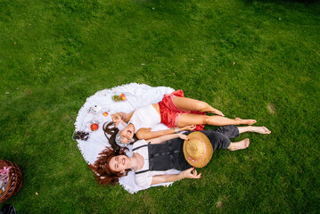 Top view, two young women lying in the park