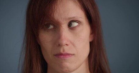 Woman blowing on annoyed long forelock, close-up view