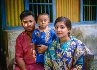 Portrait of south asian hindu religious nuclear family, young couple with their child 